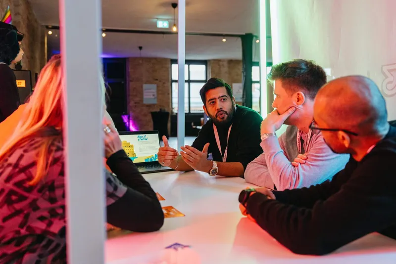 2 teams of the hackathon in discussion of technical details of their challenges